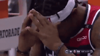 A Basketball Player Wearing A Mask And A Gatorade Bottle In The Background GIF