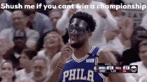 A Basketball Player Wearing A Mask Is Smoking A Cigarette In Front Of A Crowd Of People . GIF