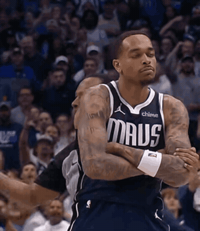 A Basketball Player Wearing A Maus Jersey Stands With His Arms Crossed GIF