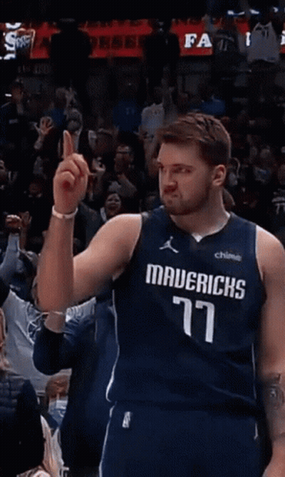 A Basketball Player Wearing A Mavericks Jersey Points To The Crowd GIF