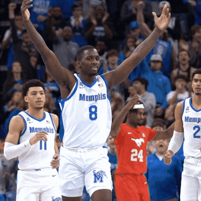 A Basketball Player Wearing A Memphis Jersey Stands With His Arms In The Air GIF