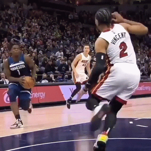A Basketball Player Wearing A Minnesota Jersey Is Running With The Ball GIF