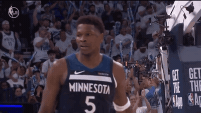 A Basketball Player Wearing A Minnesota Jersey Is Standing In Front Of A Crowd GIF