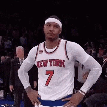 A Basketball Player Wearing A New York Jersey Is Standing With His Hands On His Hips On A Court . GIF