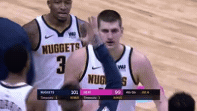 A Basketball Player Wearing A Nuggets Jersey Gives A High Five GIF