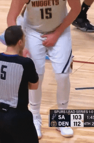 A Basketball Player Wearing A Nuggets Jersey Is Talking To A Referee GIF