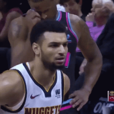 A Basketball Player Wearing A Nuggets Jersey Looks At The Camera GIF