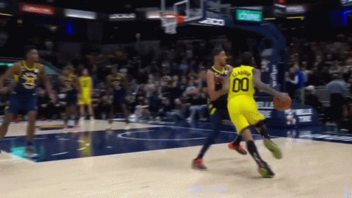 A Basketball Player Wearing A Number 00 Jersey Dribbles The Ball GIF