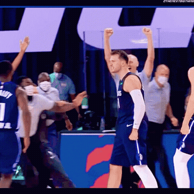 A Basketball Player Wearing A Number 1 Jersey Stands With His Fist In The Air GIF