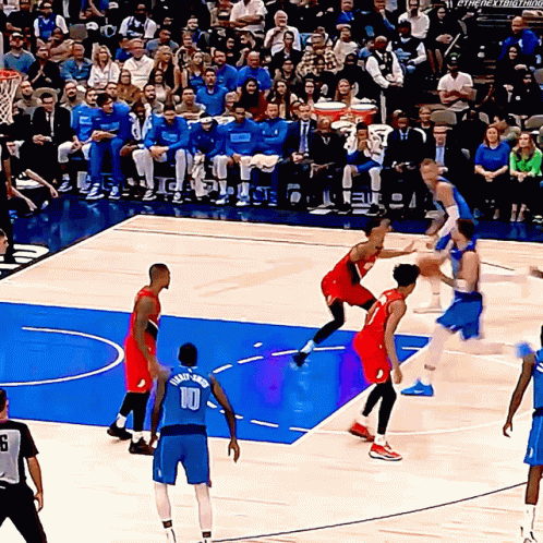 A Basketball Player Wearing A Number 10 Jersey Tries To Block A Shot GIF