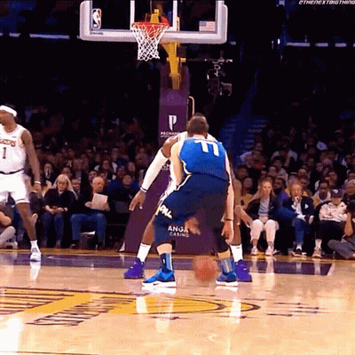A Basketball Player Wearing A Number 11 Jersey Dribbles The Ball GIF