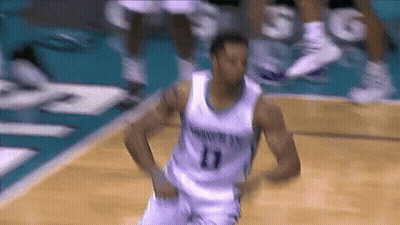 A Basketball Player Wearing A Number 11 Jersey Is Dancing On The Court GIF