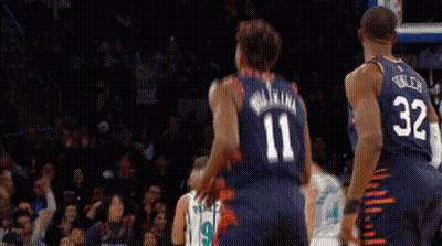 A Basketball Player Wearing A Number 11 Jersey Stands Next To A Player Wearing A Number 32 Jersey GIF