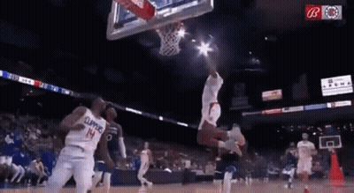 A Basketball Player Wearing A Number 14 Jersey Is Jumping In The Air While Playing Basketball . GIF