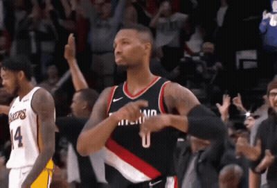 A Basketball Player Wearing A Number 14 Jersey Is Standing In Front Of A Crowd GIF