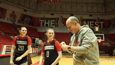 A Basketball Player Wearing A Number 20 Jersey Talks To A Man GIF