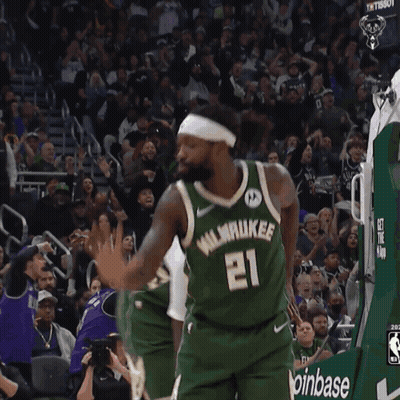 A Basketball Player Wearing A Number 21 Jersey GIF