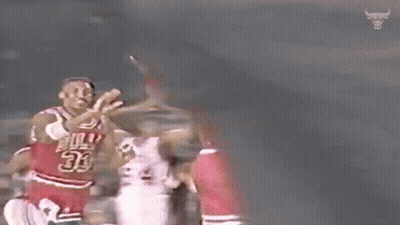 A Basketball Player Wearing A Number 23 Jersey Is Giving Another Player A High Five . GIF