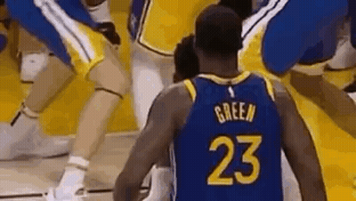 A Basketball Player Wearing A Number 23 Jersey Is Standing On A Court Surrounded By Other Players . GIF