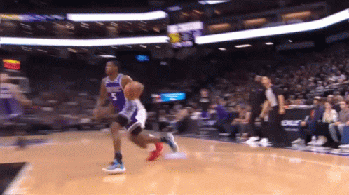 A Basketball Player Wearing A Number 5 Jersey Dribbles The Ball GIF