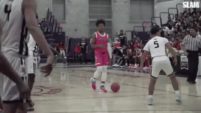 A Basketball Player Wearing A Number 5 Jersey Dribbles The Ball GIF