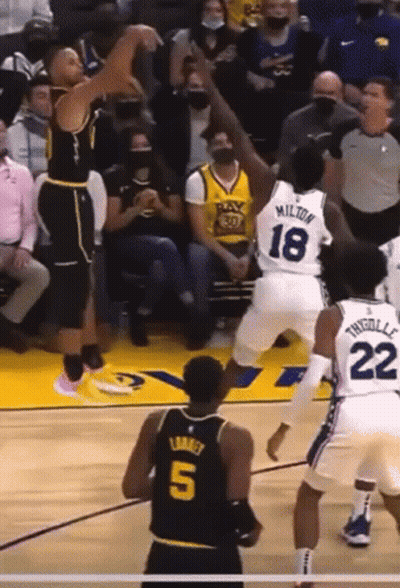 A Basketball Player Wearing A Number 5 Jersey Stands In Front Of A Player Wearing A Number 18 Jersey GIF