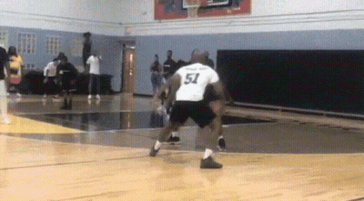A Basketball Player Wearing A Number 51 Jersey Dribbles The Ball GIF
