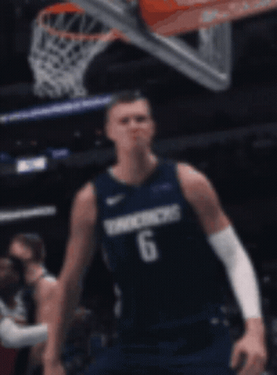 A Basketball Player Wearing A Number 6 Jersey Stands In Front Of A Basketball Net GIF