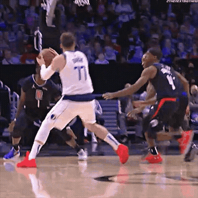 A Basketball Player Wearing A Number 77 Jersey Dribbles The Ball GIF