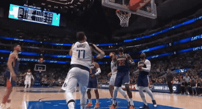 A Basketball Player Wearing A Number 77 Jersey Is Jumping In The Air GIF