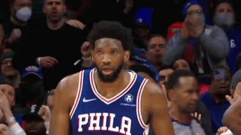 A Basketball Player Wearing A Philadelphia Jersey Stands In Front Of A Crowd . GIF