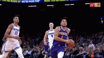 A Basketball Player Wearing A Phoenix Jersey Dribbles The Ball During A Game GIF
