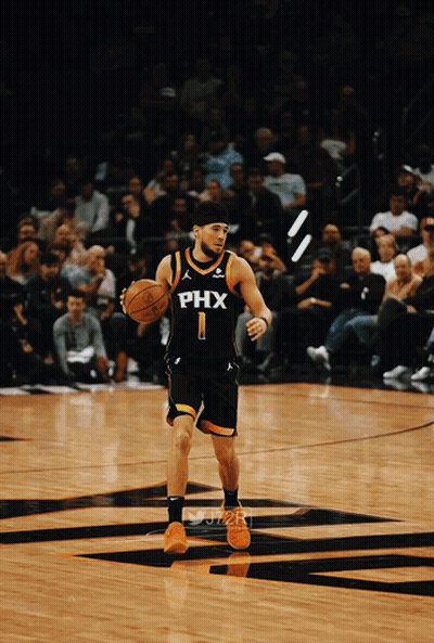 A Basketball Player Wearing A Phx Jersey Is Dribbling The Ball GIF