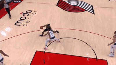 A Basketball Player Wearing A Portland Jersey Goes Up For A Shot GIF
