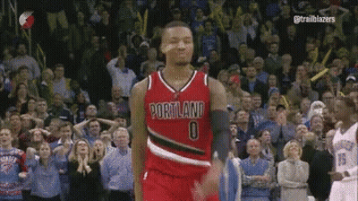 A Basketball Player Wearing A Portland Jersey Is Standing In Front Of A Crowd GIF