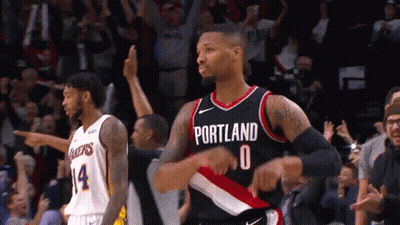 A Basketball Player Wearing A Portland Jersey Stands In Front Of A Crowd GIF