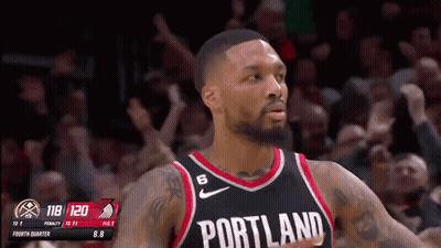 A Basketball Player Wearing A Portland Jersey Stands In Front Of The Crowd GIF