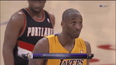 A Basketball Player Wearing A Portland Jersey Stands Next To Another Player Wearing A Yellow Lakers Jersey GIF