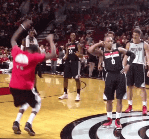 A Basketball Player Wearing A Portland Jersey Stands On The Court GIF