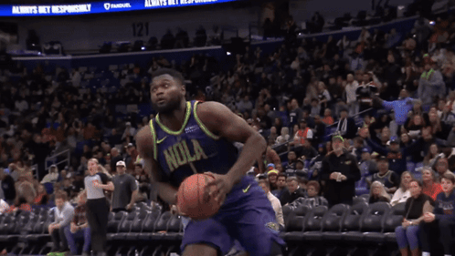 A Basketball Player Wearing A Purple And Yellow Jersey That Says ' Nola ' On It GIF