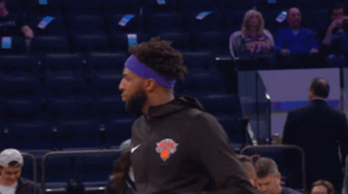 A Basketball Player Wearing A Purple Headband With The New York Knicks Logo GIF