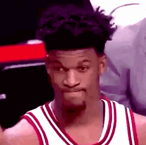 A Basketball Player Wearing A Red And White Jersey Is Making A Face . GIF