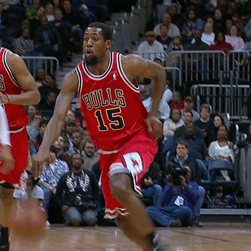 A Basketball Player Wearing A Red Bulls 15 Jersey GIF