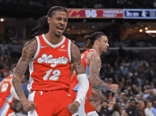 A Basketball Player Wearing A Red Jersey With Memphis 12 On It GIF
