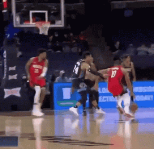 A Basketball Player Wearing A Red Jersey With The Number 10 On It Dribbles The Ball GIF