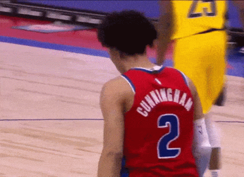 A Basketball Player Wearing A Red Jersey With The Number 2 On The Back GIF