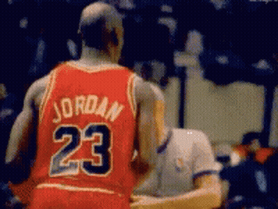 A Basketball Player Wearing A Red Jersey With The Number 23 On The Back GIF