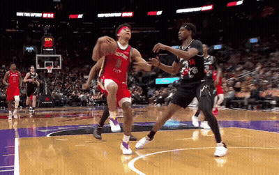 A Basketball Player Wearing A Red Jersey With The Number 8 On It Tries To Block A Player Wearing A Black Jersey GIF
