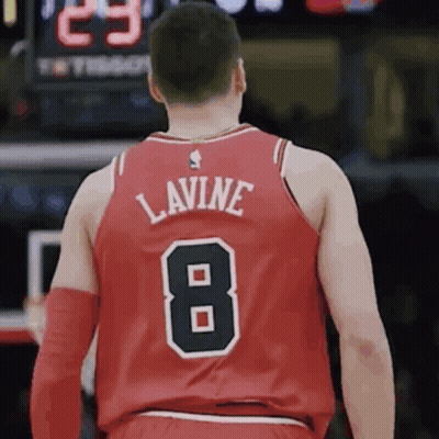 A Basketball Player Wearing A Red Jersey With The Number 8 On The Back GIF