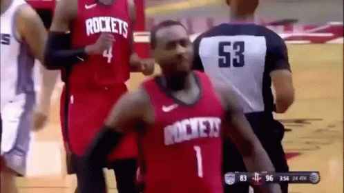 A Basketball Player Wearing A Red Jersey With The Word Rockets On It Is Dancing On The Court . GIF